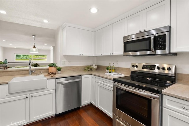 51 Sea Pine Ln, Newport Beach, CA 92660 - kitchen featuring stainless steel appliances, light countertops, white cabinetry, dark wood-type flooring, and recessed lighting