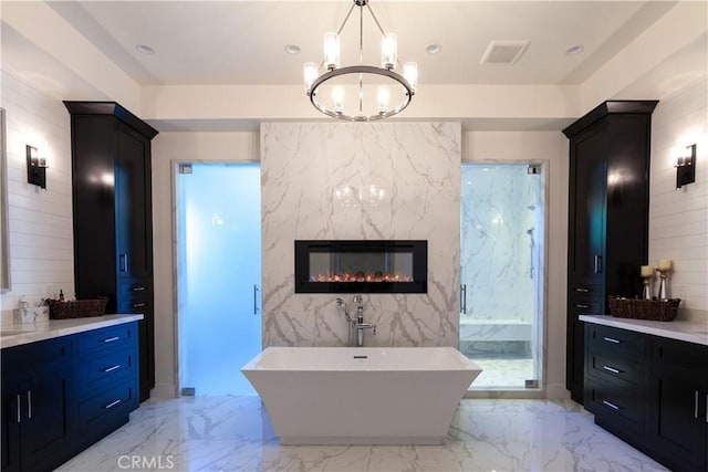 5225 Topeka Dr, Tarzana, CA 91356 - full bath with vanity, a chandelier, a soaking tub, a premium fireplace, and marble tiled flooring