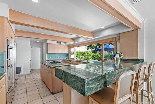 3366 Bayside Walk, San Diego, CA 92109 - kitchen featuring appliances with stainless steel finishes, decorative backsplash, light tile patterned floors, beam ceiling, and light brown cabinetry