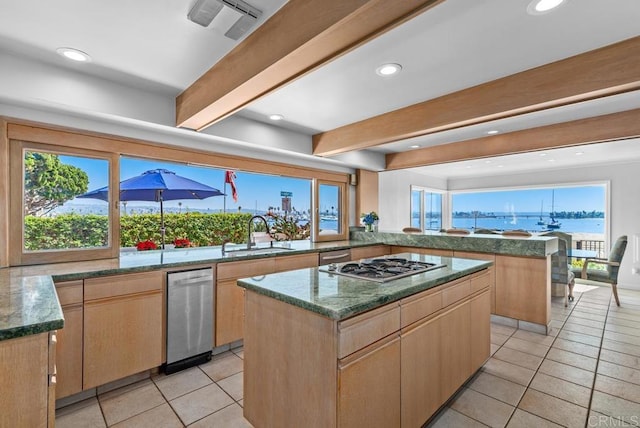 3366 Bayside Walk, San Diego, CA 92109 - kitchen featuring stainless steel gas cooktop, beamed ceiling, light tile patterned floors, a center island, and a peninsula