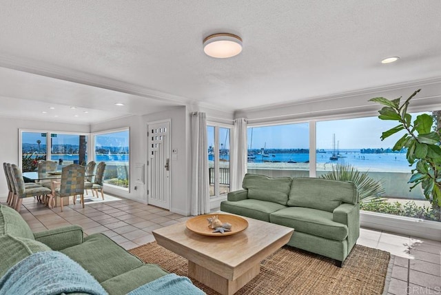 3366 Bayside Walk, San Diego, CA 92109 - living area featuring a water view, plenty of natural light, a textured ceiling, tile patterned flooring, and ornamental molding