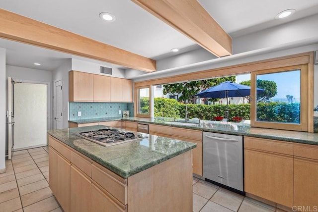 3366 Bayside Walk, San Diego, CA 92109 - kitchen with stainless steel appliances, beam ceiling, light brown cabinetry, light tile patterned flooring, and backsplash