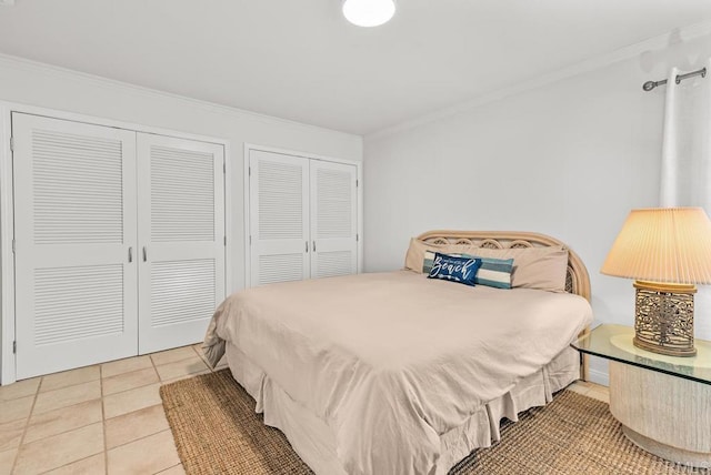 3366 Bayside Walk, San Diego, CA 92109 - bedroom with two closets, ornamental molding, and tile patterned flooring