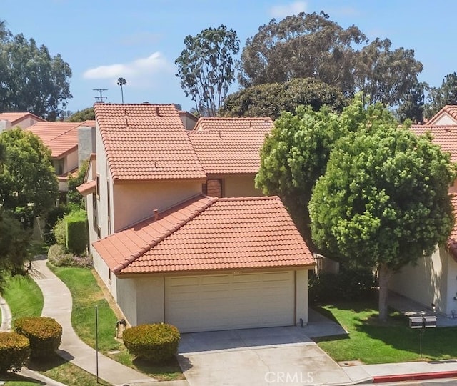 18325 Gum Tree Ln, Huntington Beach, CA 92646 - view of front of house with a tile roof, stucco siding, and driveway