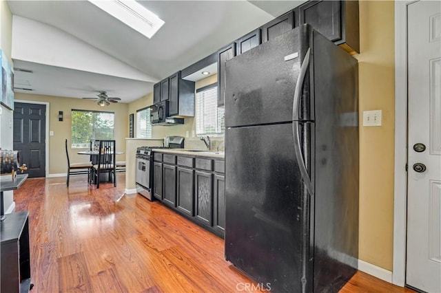 936 Gonzales St, Placentia, CA 92870 - kitchen with black appliances, lofted ceiling, light wood-type flooring, ceiling fan, and light countertops