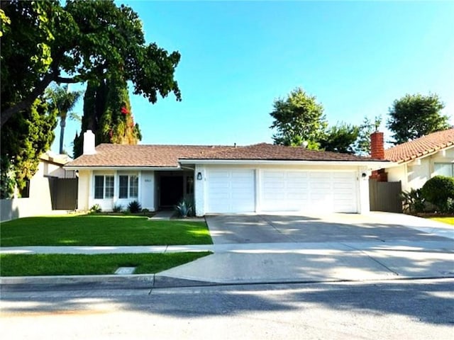 1063 Redding Ave, Costa Mesa, CA 92626 - ranch-style house with a garage, concrete driveway, a chimney, and stucco siding