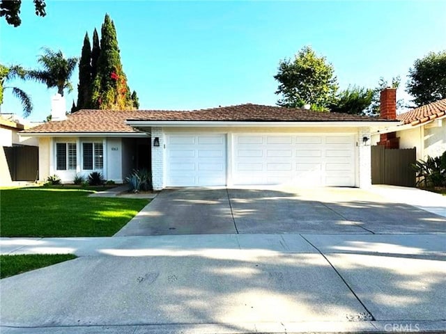 1063 Redding Ave, Costa Mesa, CA 92626 - single story home with concrete driveway, a garage, a chimney, and stucco siding