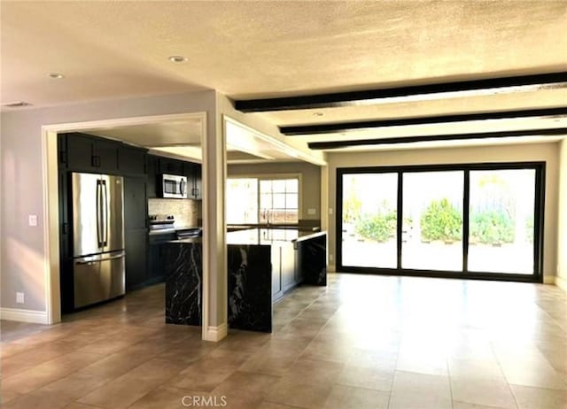1063 Redding Ave, Costa Mesa, CA 92626 - kitchen featuring stainless steel appliances, dark cabinetry, tasteful backsplash, a textured ceiling, and recessed lighting