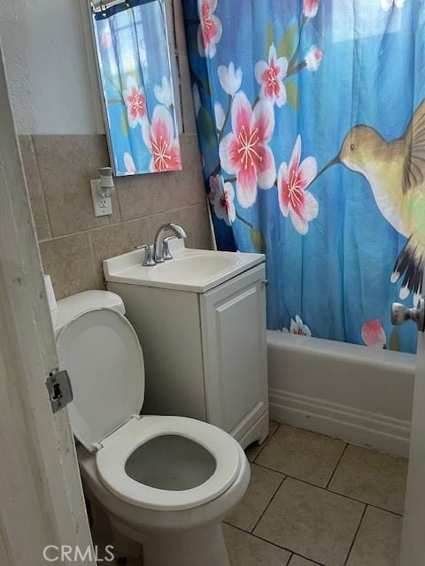 1408 S Central Ave, Compton, CA 90220 - full bathroom featuring tile patterned floors, shower / bath combo, and tile walls