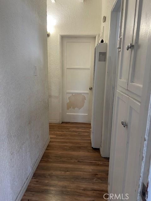 1408 S Central Ave, Compton, CA 90220 - hallway with a heating unit, dark wood-type flooring, and a textured wall