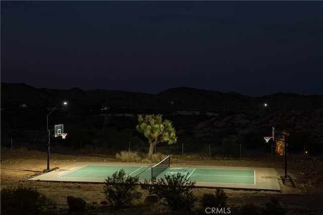 59855 Security Dr, Yucca Valley, CA 92284 - pool at night featuring a mountain view and an outdoor pool