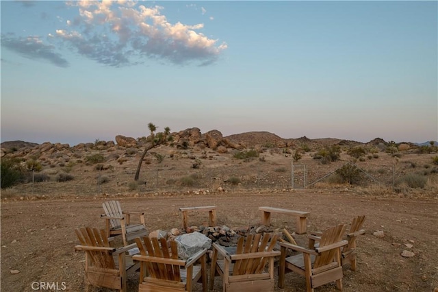 59855 Security Dr, Yucca Valley, CA 92284 - yard at dusk featuring a fire pit and a mountain view