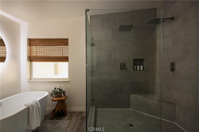 59855 Security Dr, Yucca Valley, CA 92284 - bathroom featuring a shower stall, a freestanding bath, and wood finished floors