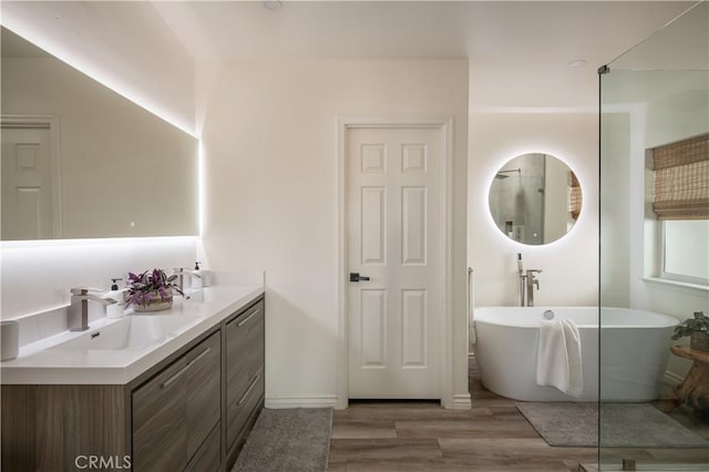 59855 Security Dr, Yucca Valley, CA 92284 - bathroom featuring wood finished floors, a freestanding tub, and double vanity