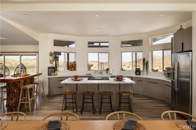 59855 Security Dr, Yucca Valley, CA 92284 - kitchen with stainless steel refrigerator with ice dispenser, a center island, a kitchen bar, healthy amount of natural light, and recessed lighting