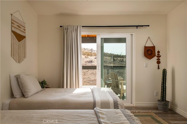 59855 Security Dr, Yucca Valley, CA 92284 - bedroom featuring wood finished floors and access to outside