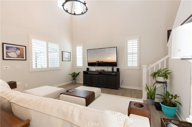 45055 Via Vela, Temecula, CA 92592 - living area with wood finished floors, plenty of natural light, stairs, a chandelier, and a high ceiling