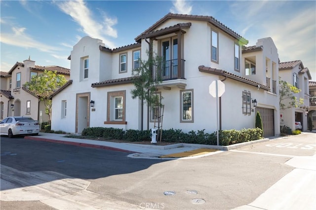 45055 Via Vela, Temecula, CA 92592 - view of front of property featuring a tiled roof, a balcony, an attached garage, and stucco siding