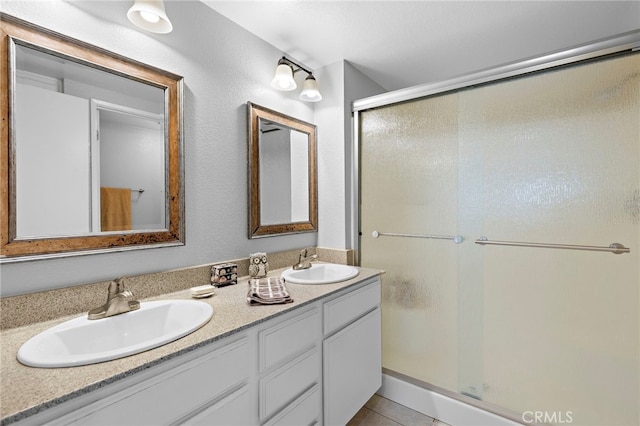 405 Ribbon Beach Way Unit 243, Oceanside, CA 92058 - bathroom featuring a shower stall, double vanity, and tile patterned flooring