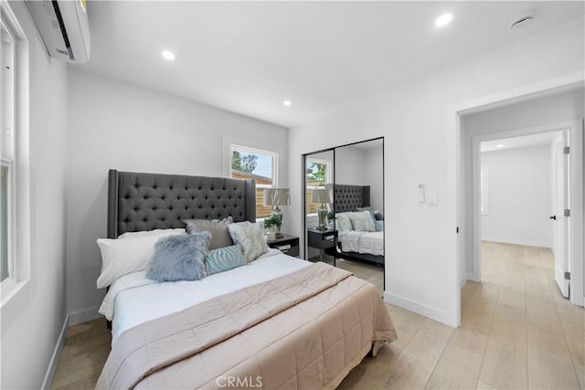 16082 Athol St, Fontana, CA 92335 - bedroom with a wall mounted air conditioner, light wood-style floors, and recessed lighting