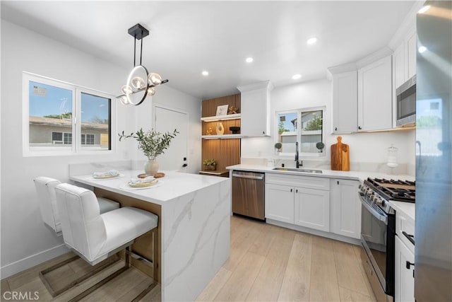 16082 Athol St, Fontana, CA 92335 - kitchen with appliances with stainless steel finishes, white cabinetry, open shelves, recessed lighting, and healthy amount of natural light
