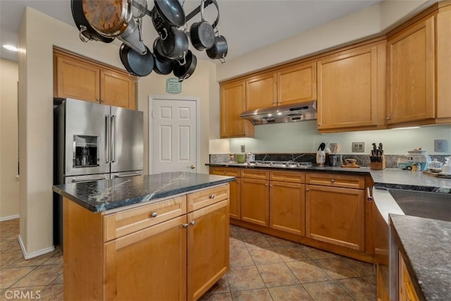 2631 Harvest Crest Ln, Corona, CA 92881 - kitchen with appliances with stainless steel finishes, under cabinet range hood, light tile patterned floors, a center island, and dark stone counters