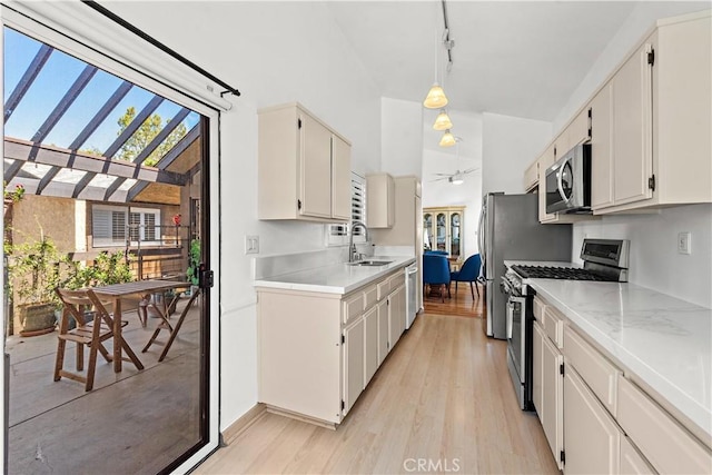 12750 Centralia St Unit 159, Lakewood, CA 90715 - kitchen with appliances with stainless steel finishes, light countertops, ceiling fan, and healthy amount of natural light