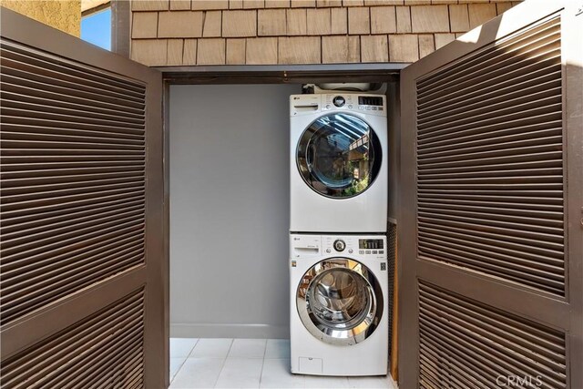 12750 Centralia St Unit 159, Lakewood, CA 90715 - washroom featuring stacked washer / dryer and light tile patterned floors