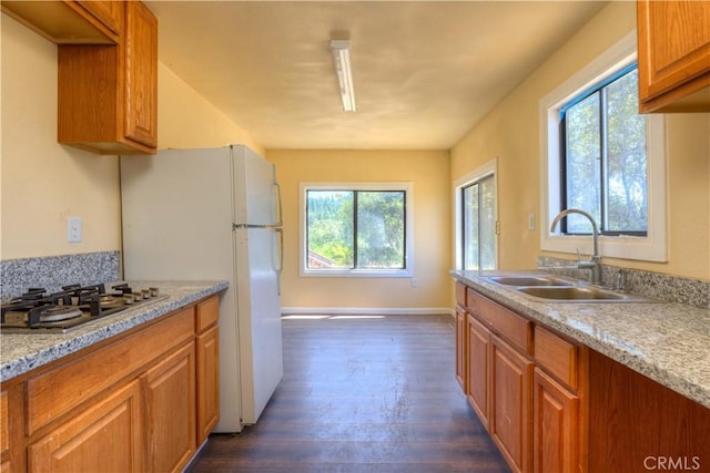 13545 Surcease Mine Rd, Oroville, CA 95965 - kitchen with dark wood-type flooring, stainless steel gas cooktop, brown cabinetry, and freestanding refrigerator