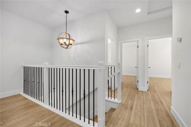 6508 Alondra Blvd, Paramount, CA 90723 - corridor with an upstairs landing, wood finished floors, a chandelier, and recessed lighting