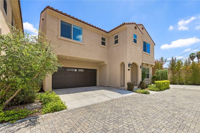 6508 Alondra Blvd, Paramount, CA 90723 - mediterranean / spanish-style home featuring stucco siding, concrete driveway, an attached garage, and a tile roof