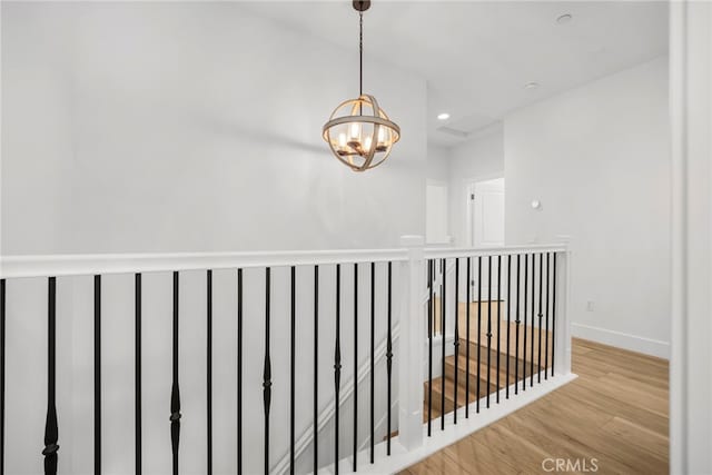 6508 Alondra Blvd, Paramount, CA 90723 - hallway with wood finished floors, a chandelier, an upstairs landing, and recessed lighting