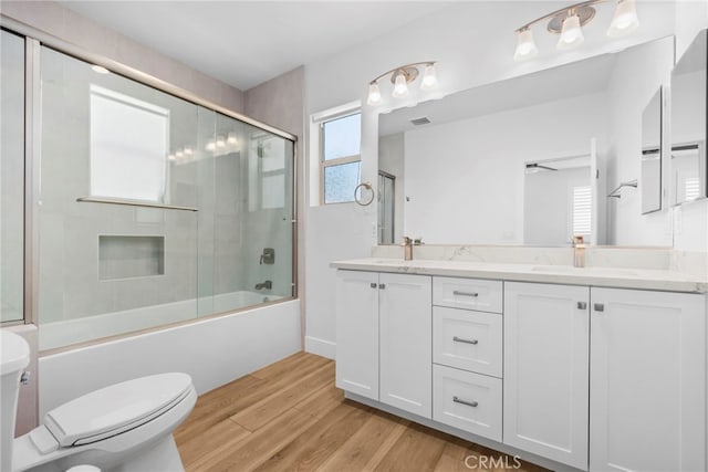 6508 Alondra Blvd, Paramount, CA 90723 - full bathroom featuring plenty of natural light, double vanity, wood finished floors, and combined bath / shower with glass door