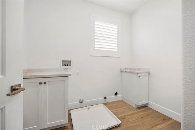 6508 Alondra Blvd, Paramount, CA 90723 - laundry area featuring hookup for a gas dryer, washer hookup, light wood-type flooring, and cabinet space