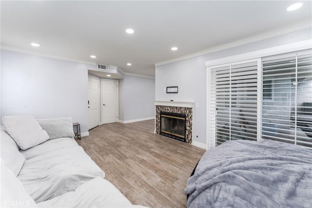 72 Corniche Dr Unit C, Dana Point, CA 92629 - living room featuring ornamental molding, recessed lighting, a glass covered fireplace, and wood finished floors