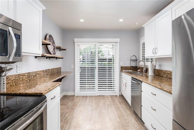 72 Corniche Dr Unit C, Dana Point, CA 92629 - kitchen with appliances with stainless steel finishes, light wood-type flooring, white cabinetry, stone counters, and open shelves