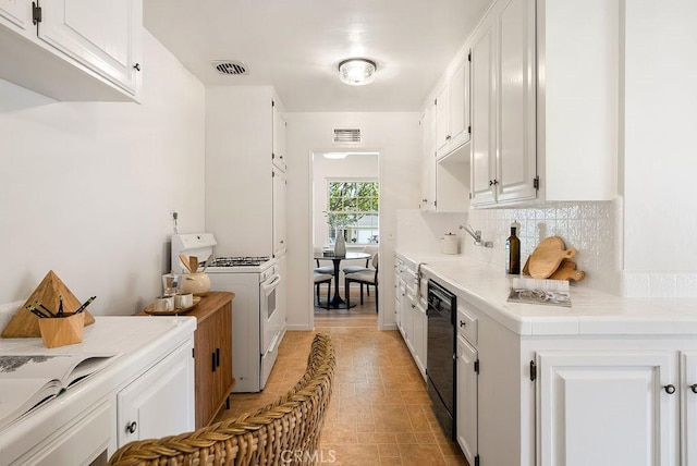 1157 Steffen St, Glendora, CA 91741 - kitchen with white gas stove, white cabinets, dishwasher, and decorative backsplash