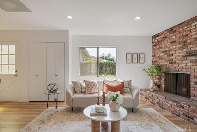 1157 Steffen St, Glendora, CA 91741 - living room featuring wood finished floors, a brick fireplace, and recessed lighting