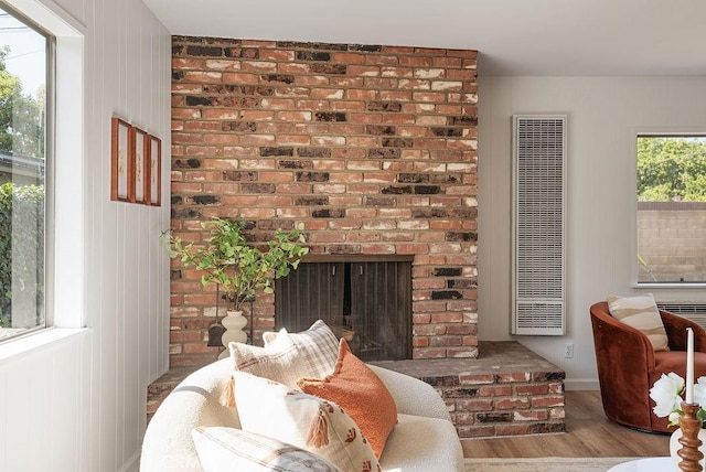 1157 Steffen St, Glendora, CA 91741 - living area featuring a heating unit, wood finished floors, and a fireplace