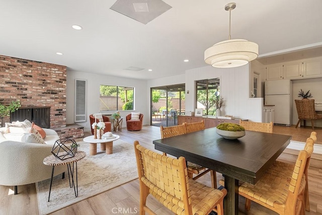 1157 Steffen St, Glendora, CA 91741 - dining room featuring light wood-style floors, recessed lighting, and a fireplace