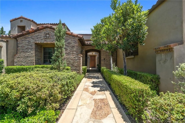 1377 Versante Cir, Corona, CA 92881 - view of front of property with a tiled roof, brick siding, and stucco siding
