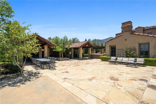 1377 Versante Cir, Corona, CA 92881 - view of patio / terrace featuring a gazebo, a mountain view, an outdoor living space, and outdoor dining area