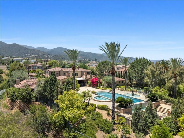 1377 Versante Cir, Corona, CA 92881 - swimming pool with an in-ground hot tub and a mountain view