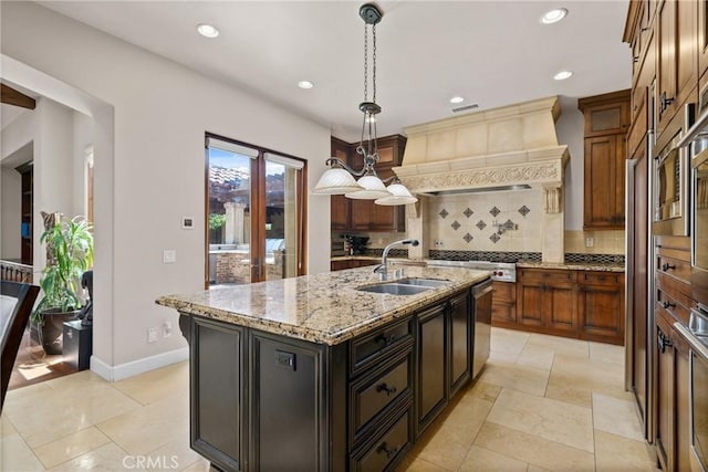 1377 Versante Cir, Corona, CA 92881 - kitchen with decorative backsplash, a kitchen island with sink, appliances with stainless steel finishes, recessed lighting, and decorative light fixtures
