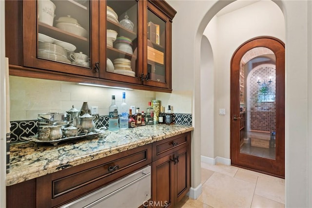 1377 Versante Cir, Corona, CA 92881 - indoor dry bar with arched walkways, decorative backsplash, and light tile patterned floors