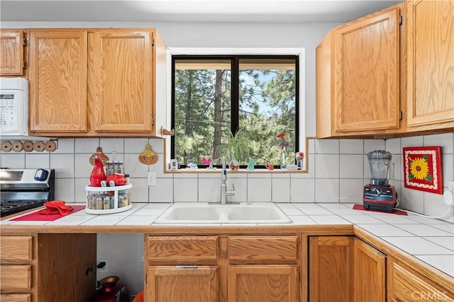1876 Sparrow Rd, Wrightwood, CA 92397 - kitchen featuring white microwave, tile countertops, backsplash, and stainless steel electric range oven