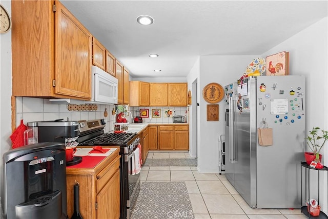 1876 Sparrow Rd, Wrightwood, CA 92397 - kitchen featuring stainless steel appliances, tasteful backsplash, light tile patterned floors, light countertops, and recessed lighting