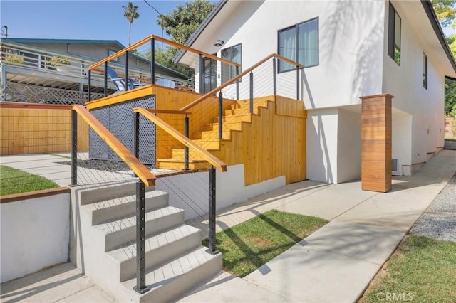 351 Vista Pl, Los Angeles, CA 90042 - view of side of home featuring stucco siding and stairway