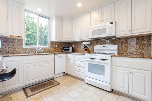 740 S Orange Grove Blvd Unit 7, Pasadena, CA 91105 - kitchen with white appliances, dark stone counters, white cabinets, tasteful backsplash, and recessed lighting