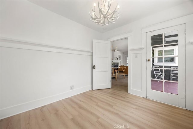 1111 Dawson Ave, Long Beach, CA 90804 - unfurnished room with a chandelier and light wood-style flooring